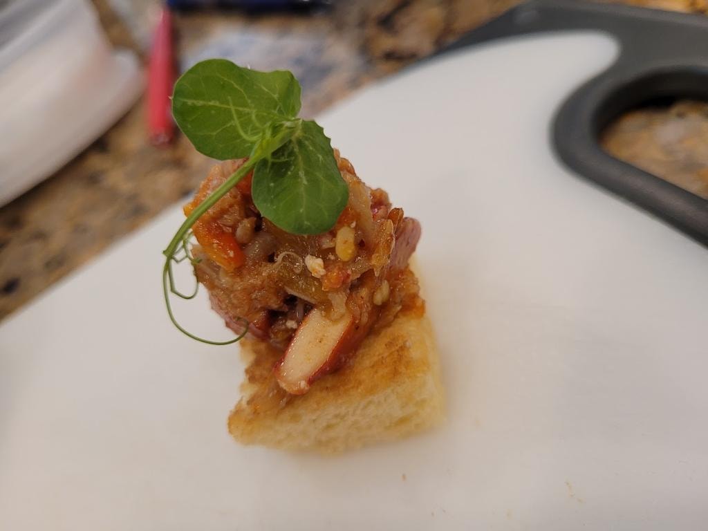 Gourmet appetizer with meat and microgreens on toast