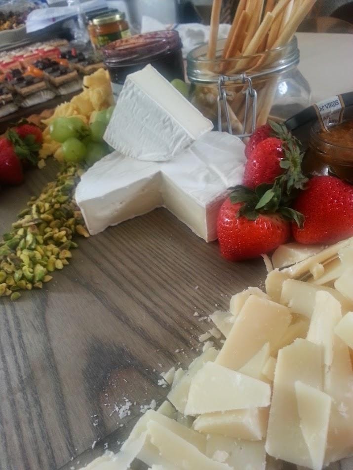Charcuterie board with cheese, strawberries, and crackers