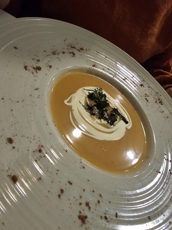 Gourmet soup with cream and seaweed garnish