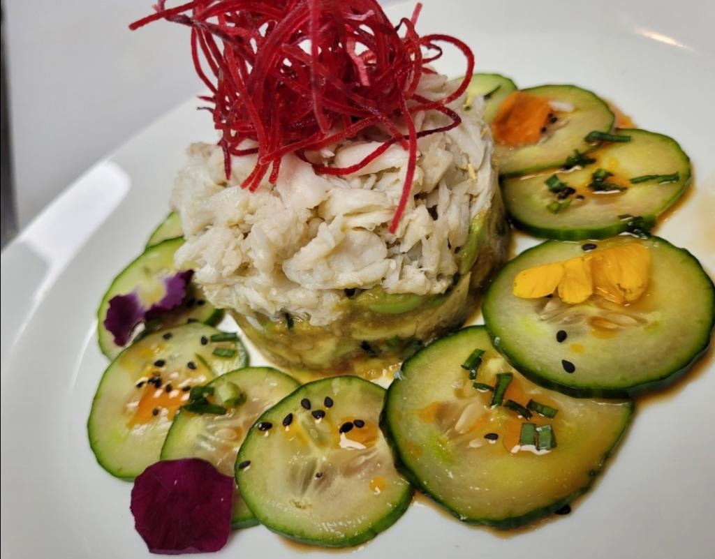 Crab salad with avocado slices and beet garnish