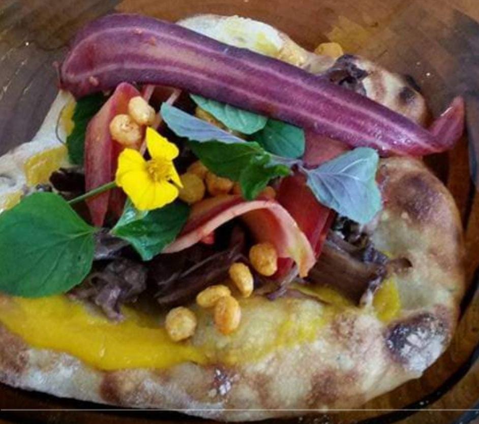 Gourmet sandwich with edible flowers and vegetables