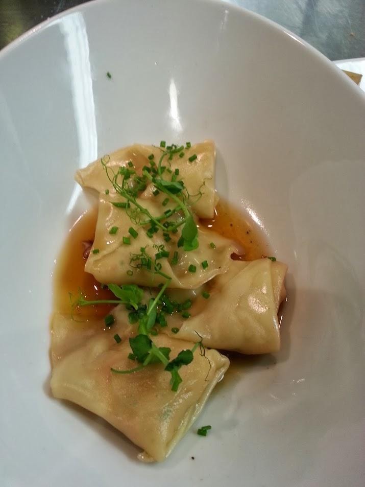 Dumplings in broth with chives