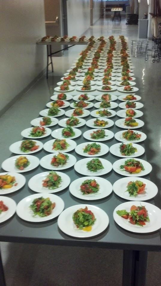 Rows of plated salads at catering event