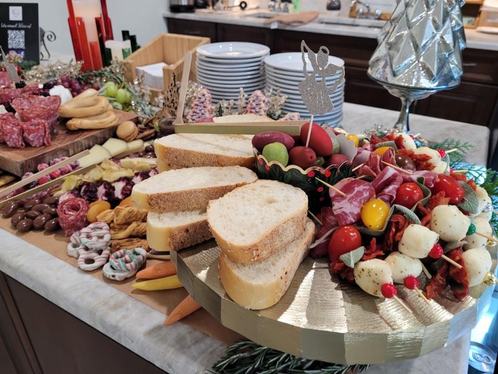 Elaborate charcuterie board with bread, fruit, and meats