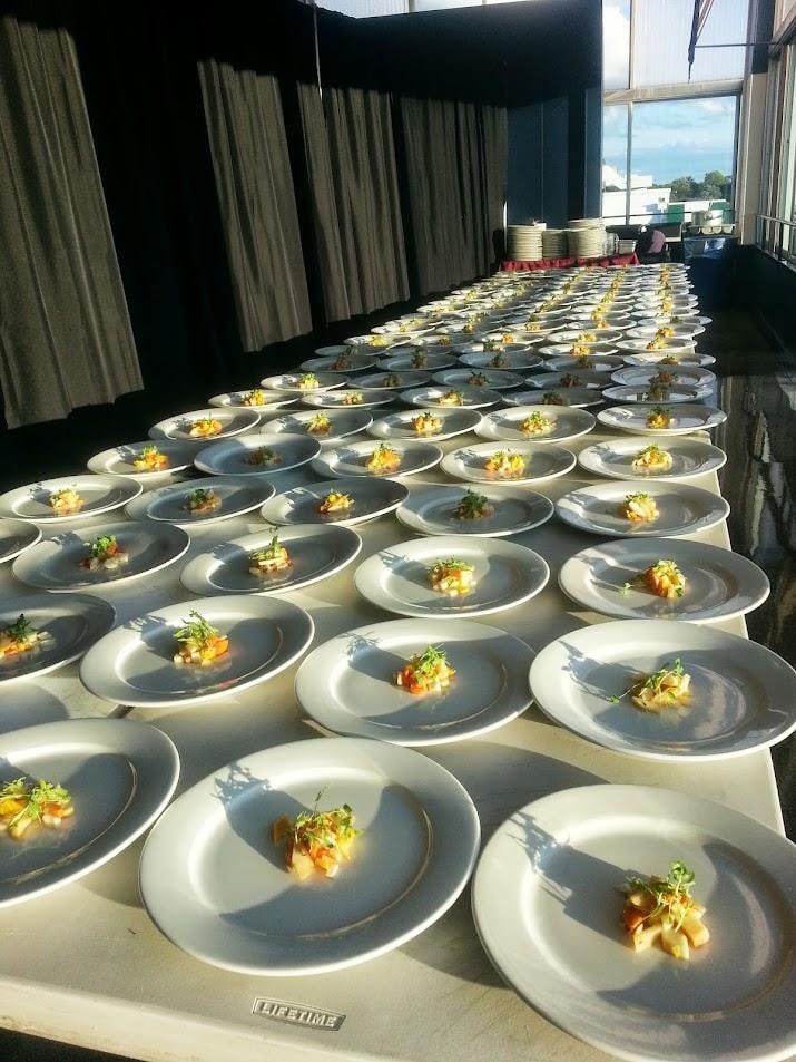 Rows of plated appetizers at event venue