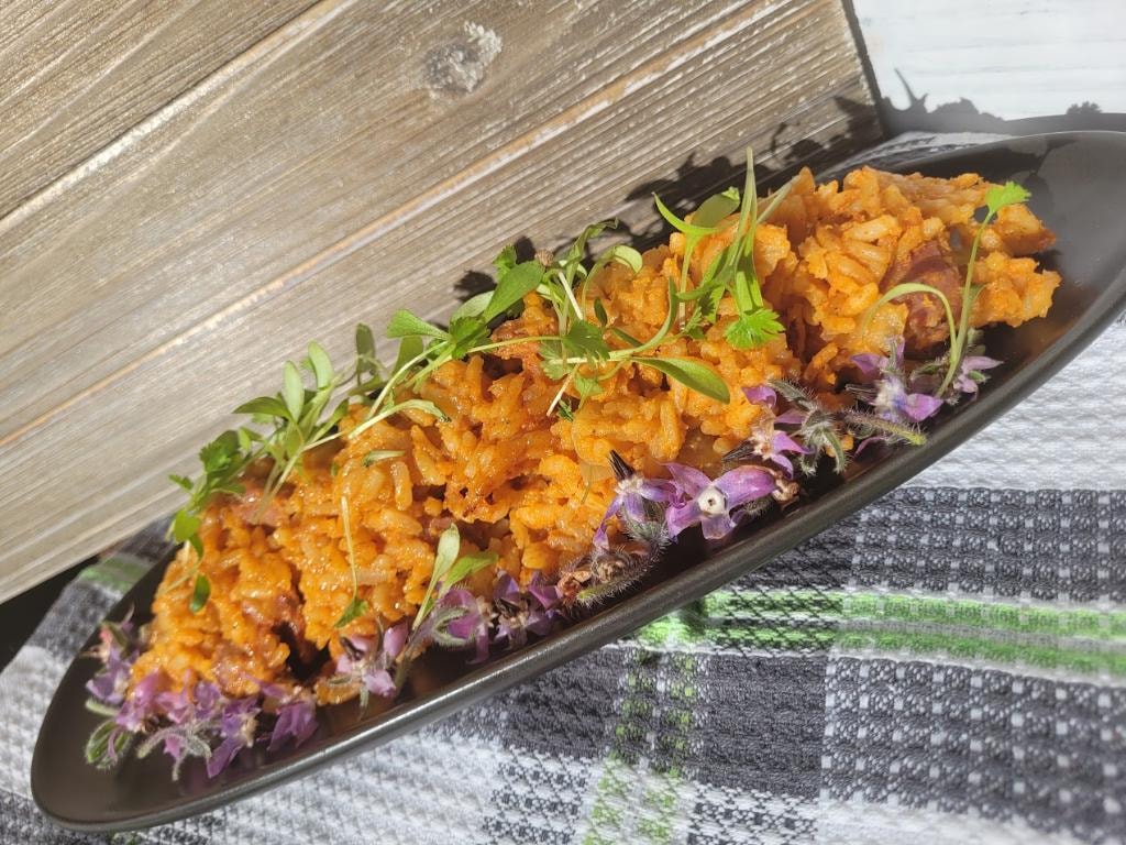 Saffron rice with microgreens and purple flowers