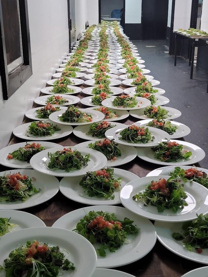 Rows of plated salads in hallway