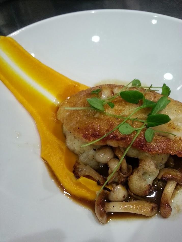 Seared fish with mushrooms and yellow sauce