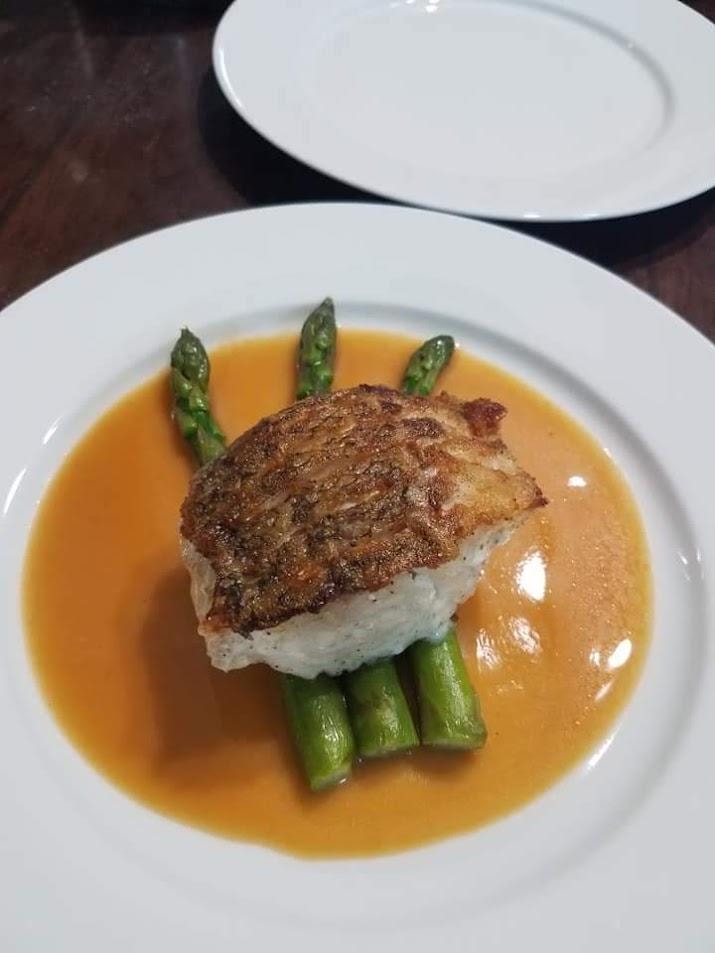 Seared fish with asparagus and golden sauce