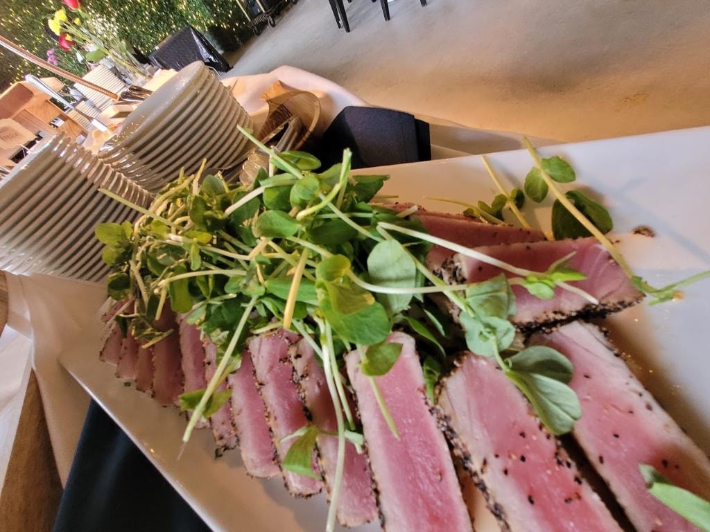 Seared tuna slices with microgreens garnish