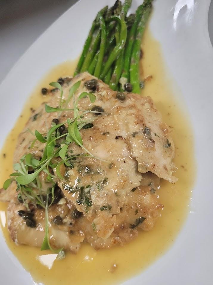Seared scallops with asparagus, capers, and lemon sauce