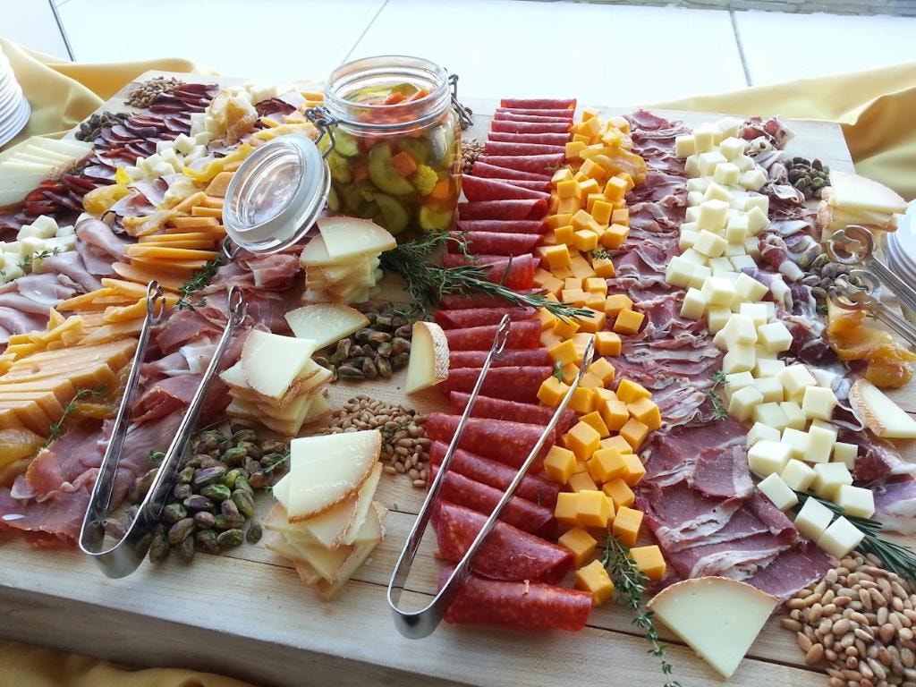 Elaborate charcuterie and grazing board with cured meats, cheeses, and accompaniments