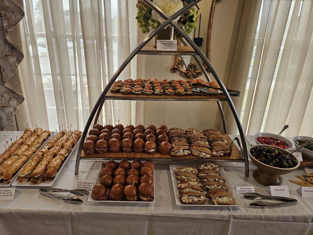Tiered display of gourmet pastries and appetizers