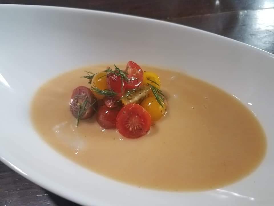 Creamy soup with roasted tomatoes and rosemary