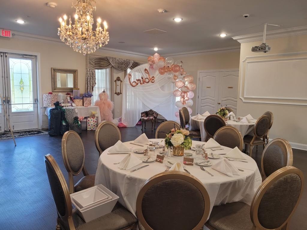 Wisteria venue with formal place settings, banquet tables, and audiovisual equipment
