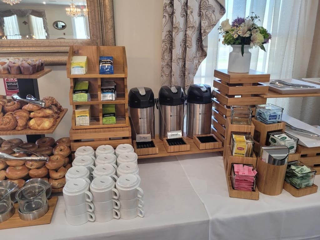 Coffee and tea station with pastries and floral decor
