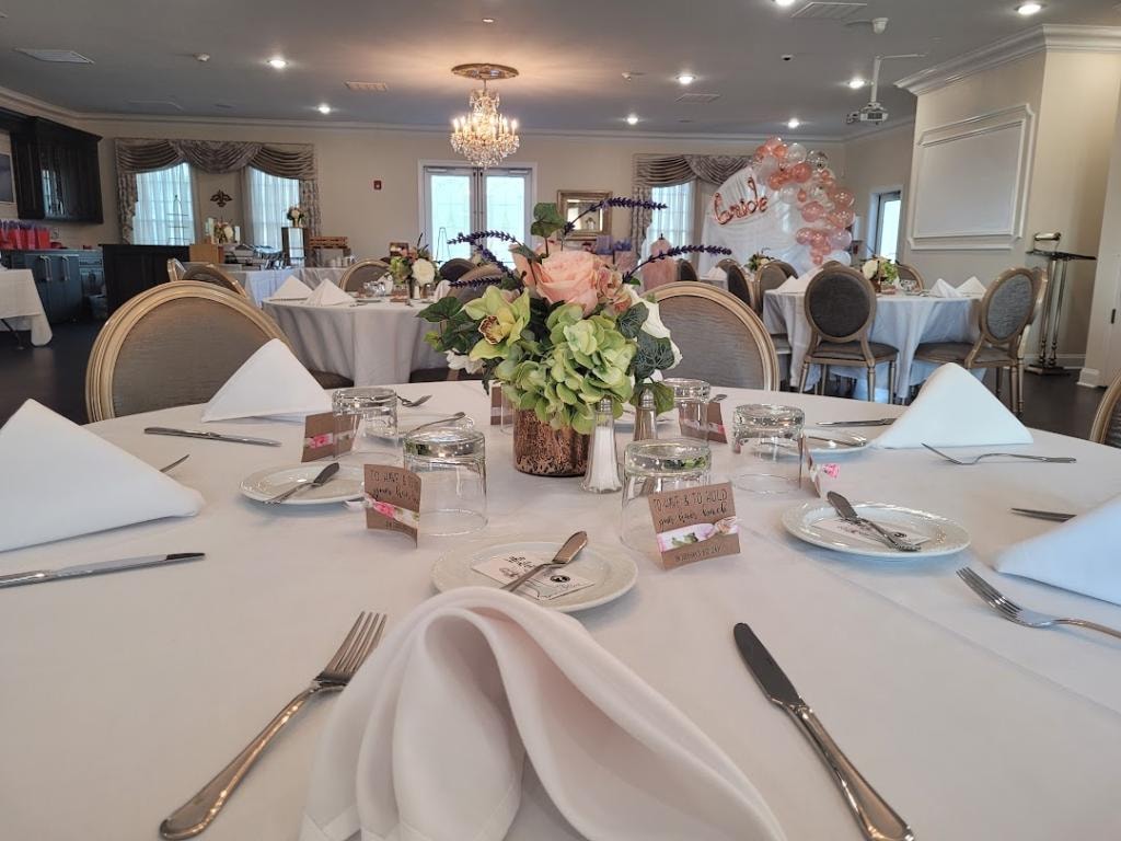 Wisteria event venue set for a formal celebration with floral centerpieces and chandeliers
