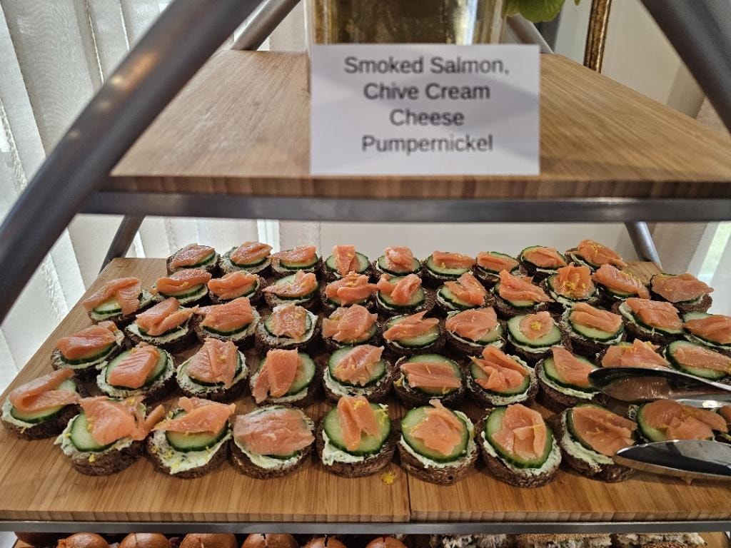 Smoked salmon and cucumber canapés with chive cream cheese on pumpernickel