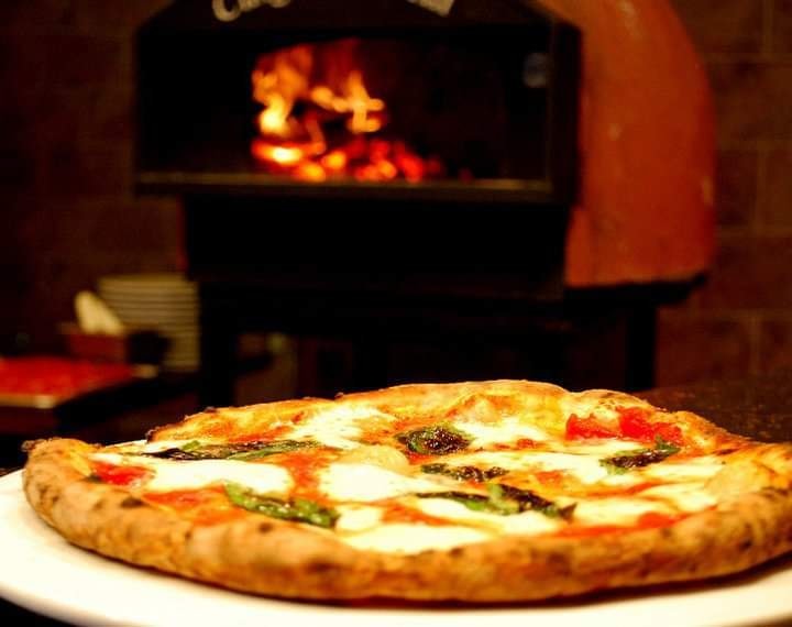 Wood-fired pizza with mozzarella and basil
