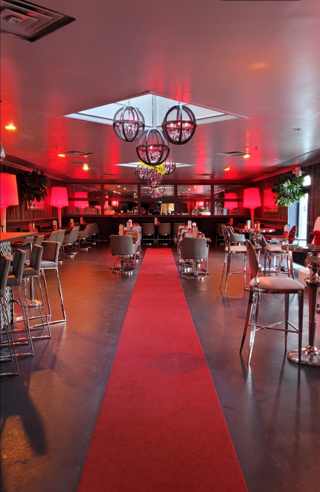 Modern event venue with red carpet lighting