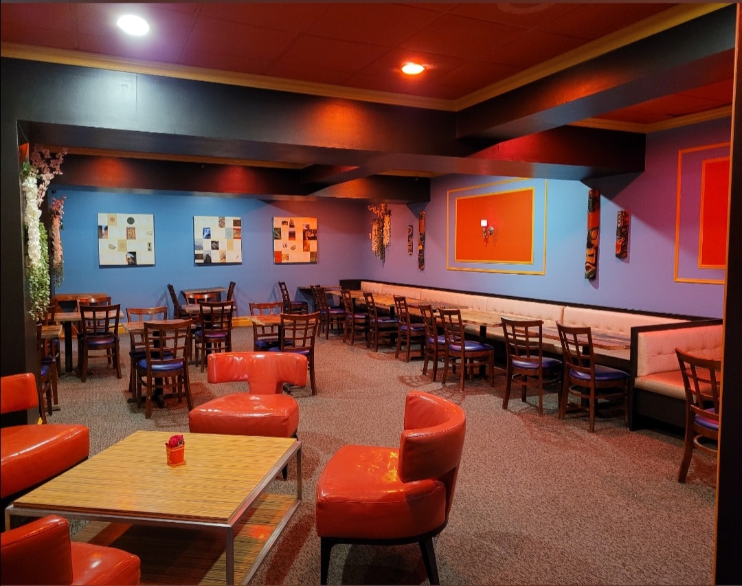 Modern lounge with red seating and blue walls