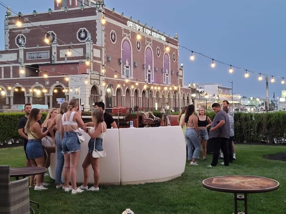 People gathering at outdoor event, historic building