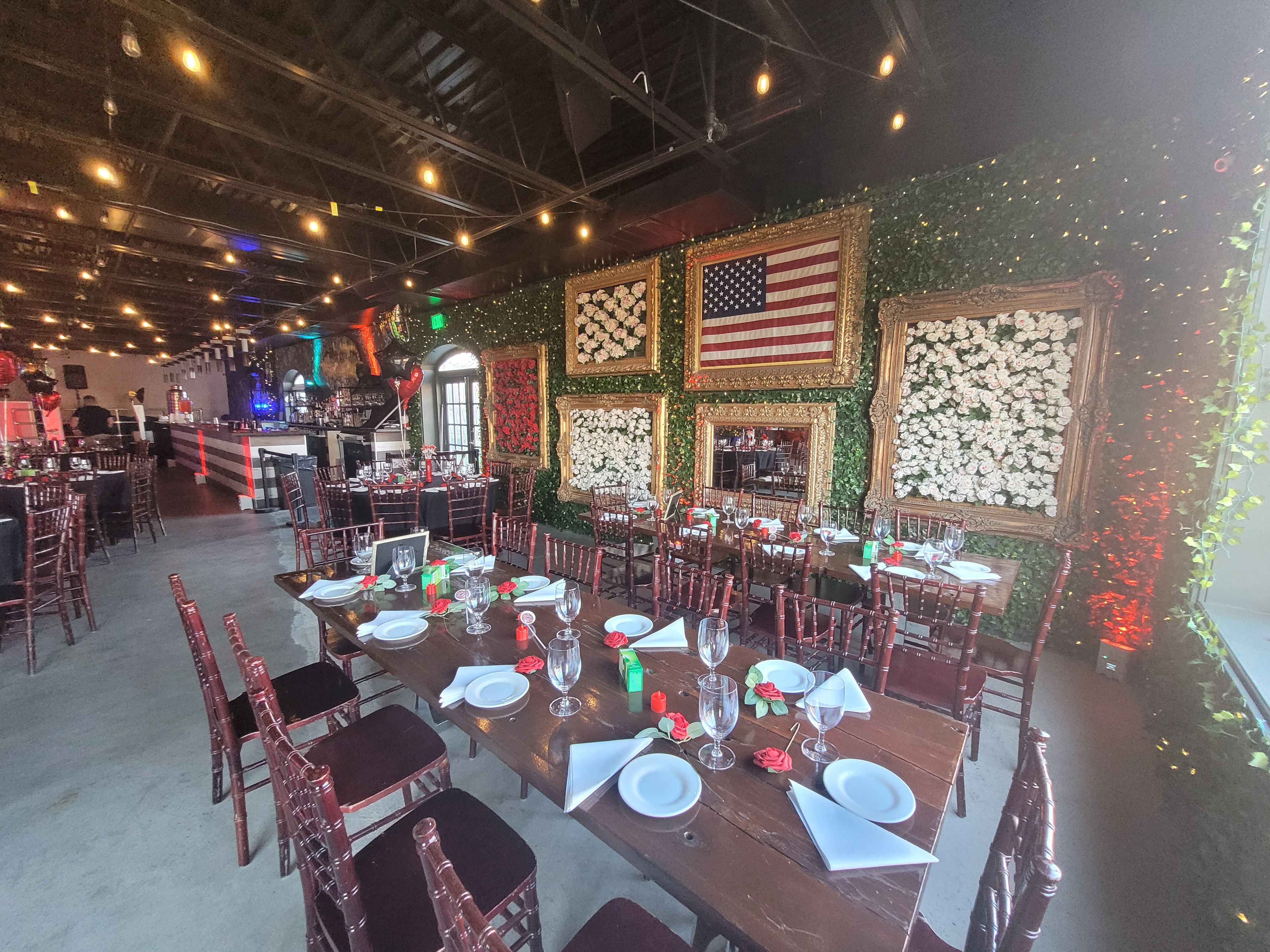 Johnny and June event venue with ivy wall, gold frames and American flag decor