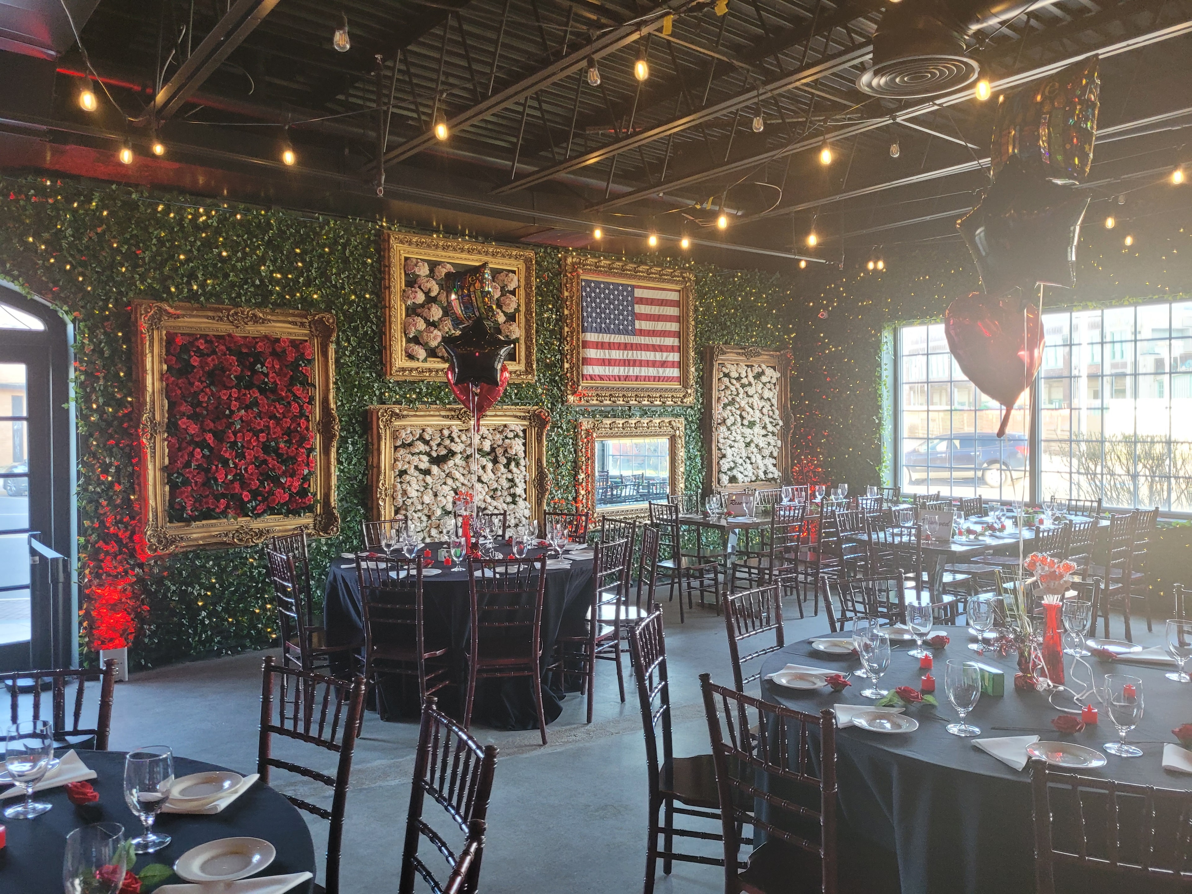 Johnny and June banquet hall with red rose wall art and round tables