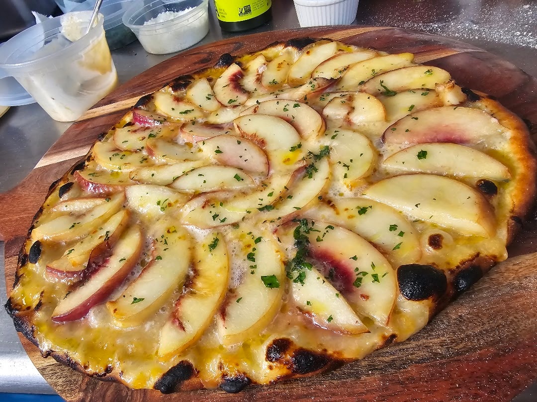 Apple pear pizza with melted cheese and herbs