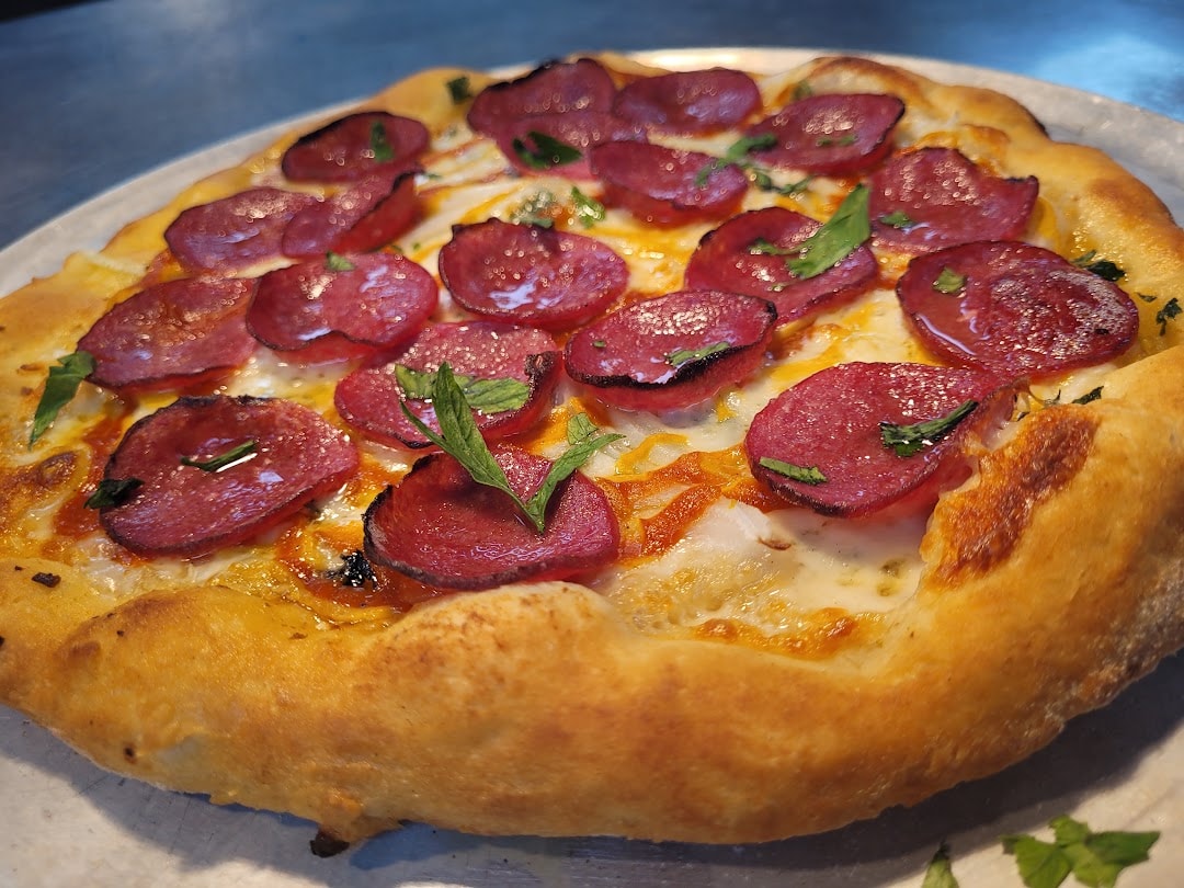Pepperoni pizza with fresh basil