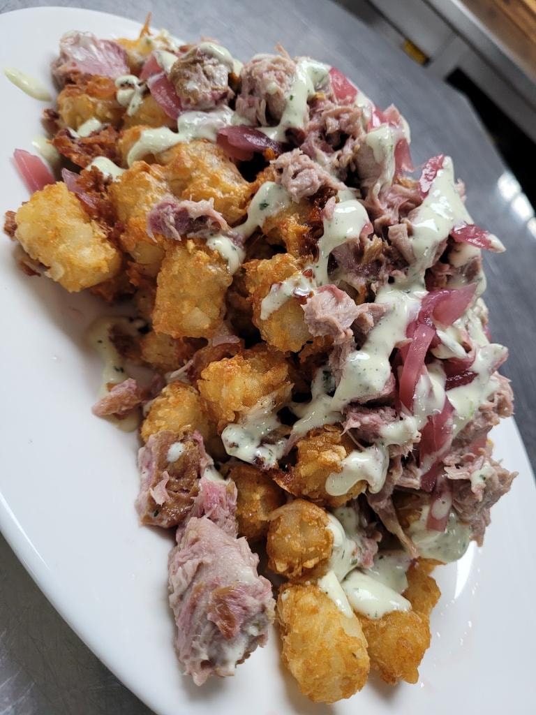 Johnny and June loaded tater tots with pulled meat and pickled onions