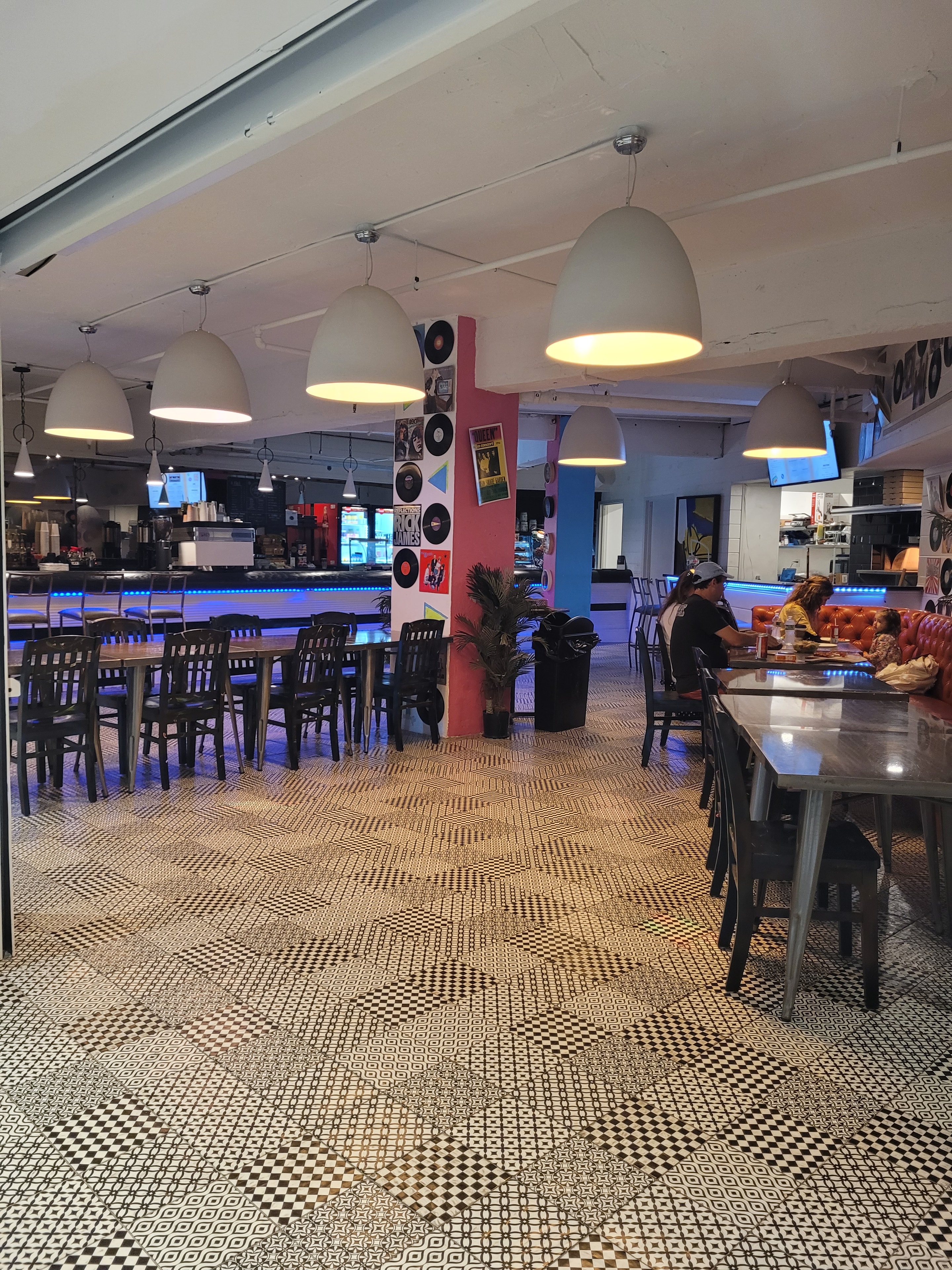 Rewind Pizzarama retro dining room with pendant lights and record wall art