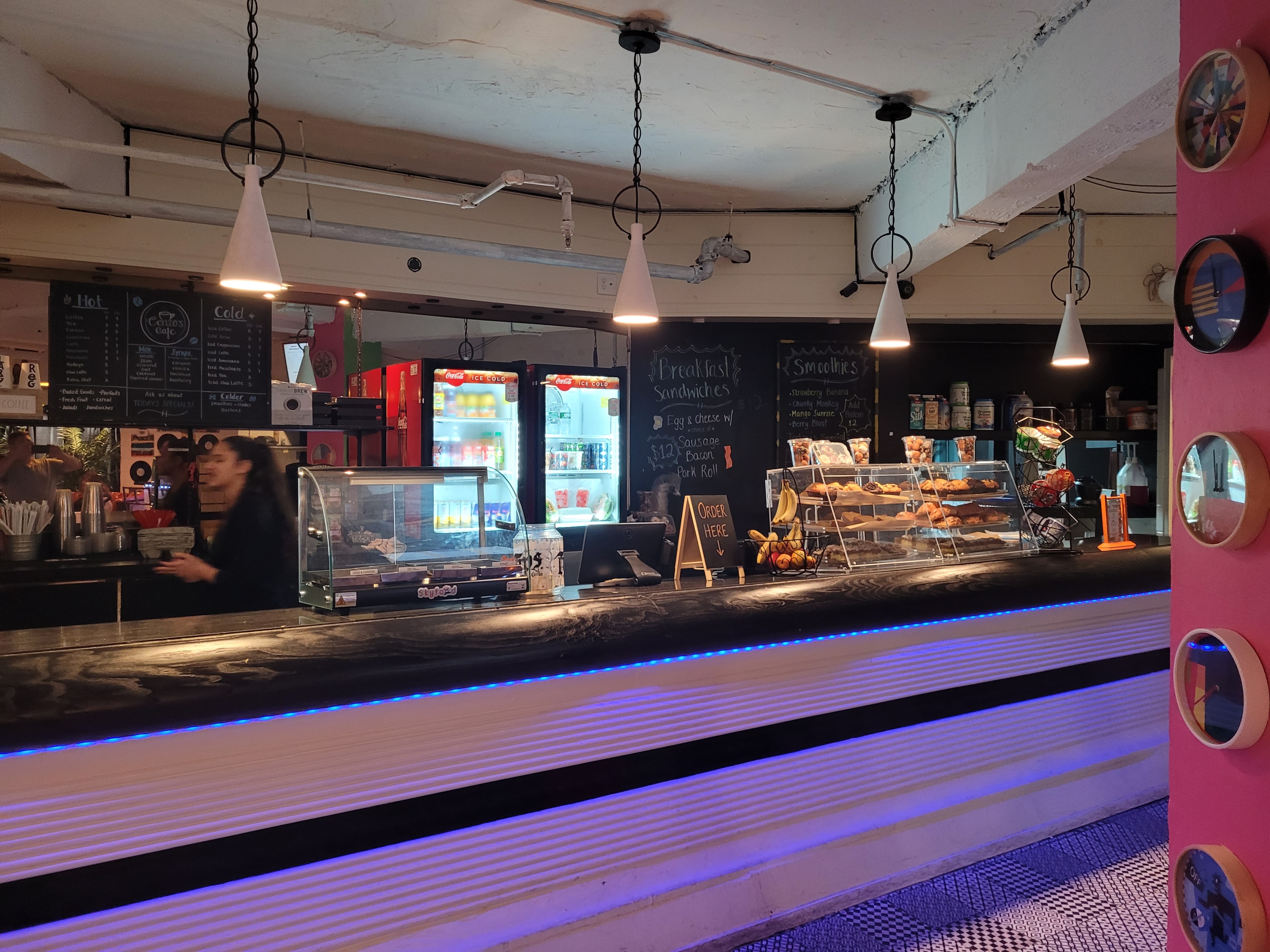 Rewind Pizzarama breakfast café counter with chalkboard menus and pastry display