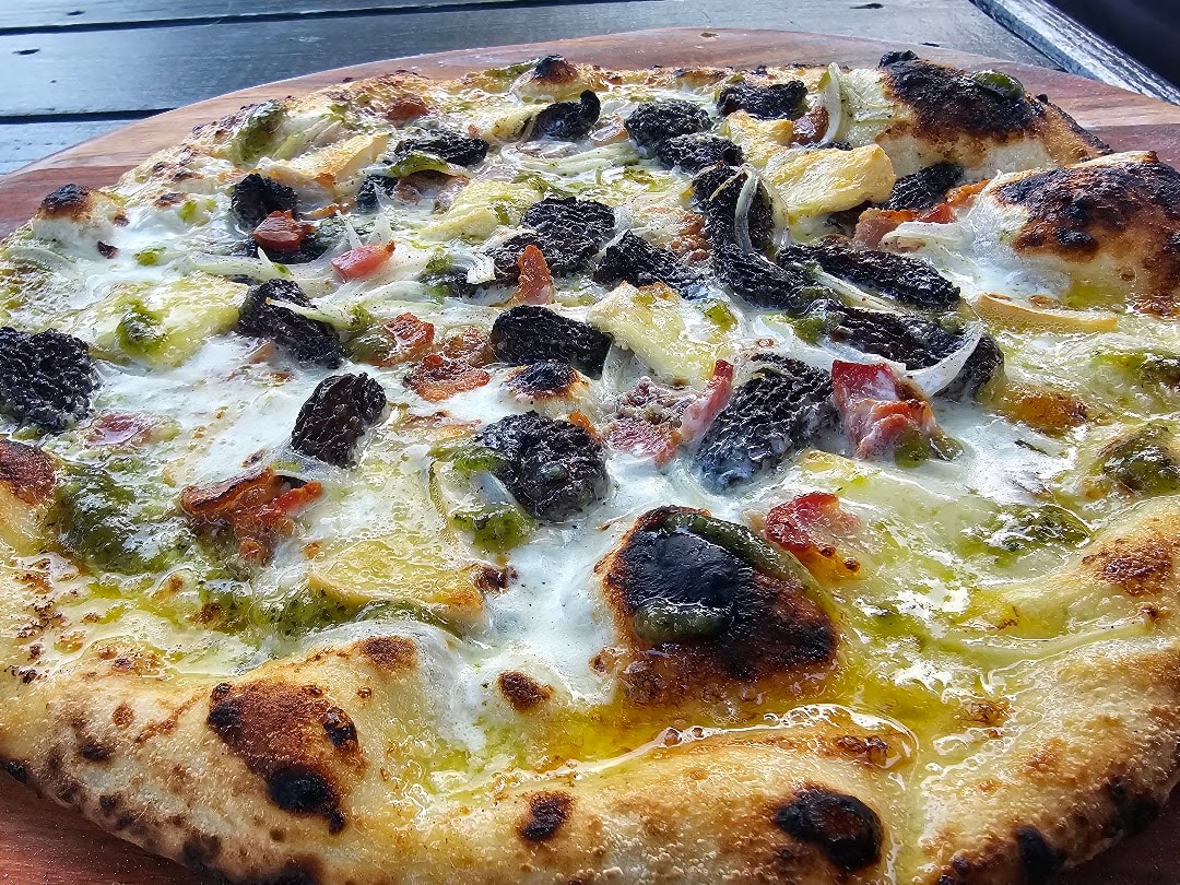 Wood-fired pizza with peppers and olives