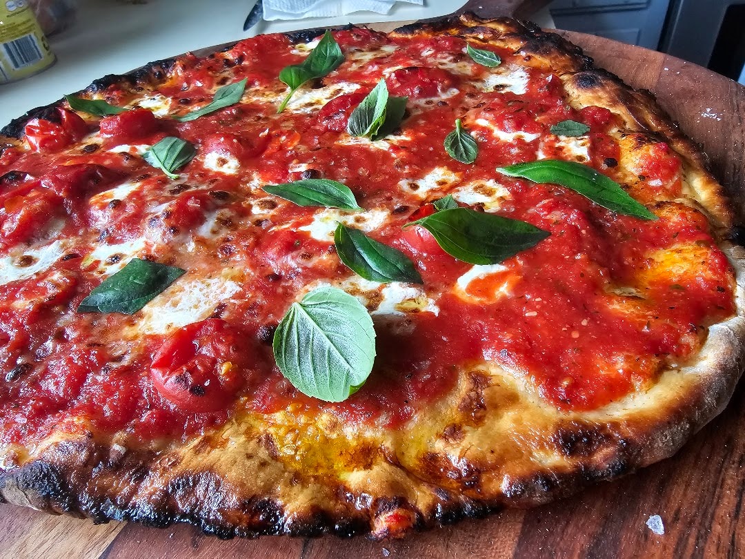 Fresh baked margherita pizza with basil