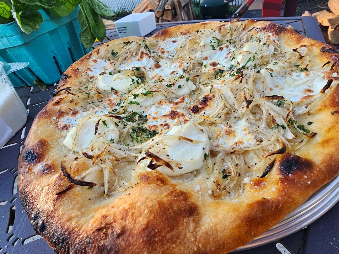 Baked focaccia with caramelized onions and herbs