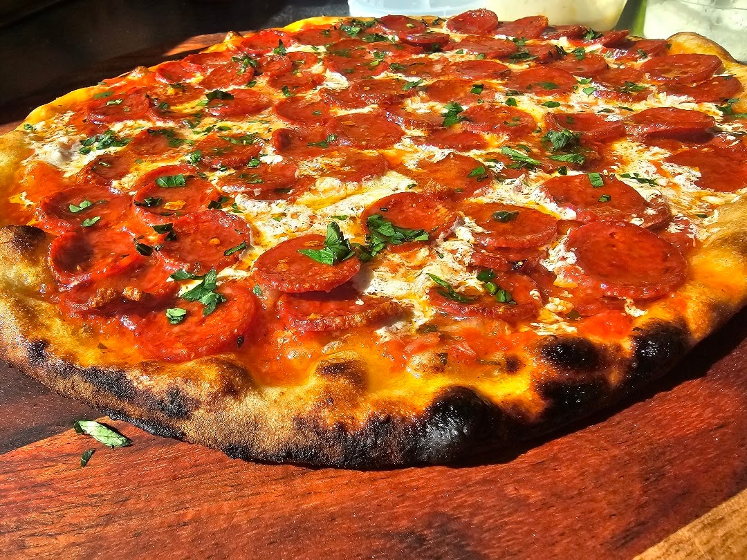 Pepperoni pizza with fresh basil